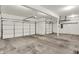 Spacious three car garage featuring concrete floors and white garage doors at 3996 Brockton Manor N Dr, Greenwood, IN 46143