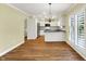 Spacious kitchen featuring stainless steel appliances, white cabinetry and backsplash, overlooking the cozy dining space at 3996 Brockton Manor N Dr, Greenwood, IN 46143