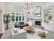 Bright living room featuring a cozy fireplace, built-in bookshelves, and lots of natural light at 3996 Brockton Manor N Dr, Greenwood, IN 46143