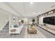 Comfortable living room with a sofa, coffee table, wall-mounted TV, carpet and decor at 3996 Brockton Manor N Dr, Greenwood, IN 46143