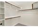 Spacious walk-in closet boasts ample shelving and rod space for storage at 3996 Brockton Manor N Dr, Greenwood, IN 46143