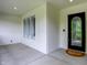 Covered front porch with a dark front door, sidelight window, and neutral-toned mat at 3996 Brockton Manor N Dr, Greenwood, IN 46143