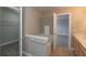 This bathroom features a bathtub, oak vanity and doorway to the bedroom and walk-in closet at 4104 Bullfinch Way, Westfield, IN 46062