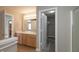 This bathroom features a dual vanity and a doorway to a walk-in closet with shelving at 4104 Bullfinch Way, Westfield, IN 46062