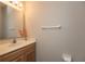 This bathroom includes a white porcelain sink set in an oak vanity with a decorative vase of flowers at 4104 Bullfinch Way, Westfield, IN 46062