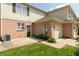 Brick and vinyl townhome includes a garage, patio, and green space at 4104 Bullfinch Way, Westfield, IN 46062