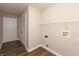 A well-lit laundry room features a door, wood floors, washer hookups, and a hanging rack at 4104 Bullfinch Way, Westfield, IN 46062