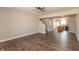 A bright living room features wood floors, a ceiling fan, and an open floorplan that flows into the kitchen at 4104 Bullfinch Way, Westfield, IN 46062