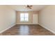 A bright living room features wood floors, a ceiling fan, and a large window for natural light at 4104 Bullfinch Way, Westfield, IN 46062
