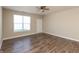 A bright living room features wood floors, a ceiling fan, and a large window that gives a lot of natural light at 4104 Bullfinch Way, Westfield, IN 46062