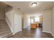 A bright living room features wood floors and an open staircase that leads to the upper floors of the home at 4104 Bullfinch Way, Westfield, IN 46062