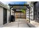 Small backyard patio with black pergola and grill at 413 E 40Th St, Indianapolis, IN 46205