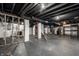 Unfinished basement with painted ceiling, white-painted cinder block walls, and modern appliances at 413 E 40Th St, Indianapolis, IN 46205