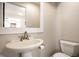 Updated bathroom with a pedestal sink and modern toilet at 413 E 40Th St, Indianapolis, IN 46205