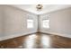 Neutral bedroom with hardwood floors, two windows, and white trim at 413 E 40Th St, Indianapolis, IN 46205