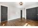 Bedroom with hardwood floors, ceiling fan, closet, and adjoining door at 413 E 40Th St, Indianapolis, IN 46205