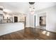 Open-concept dining room with hardwood floors leading to a modern kitchen and living area at 413 E 40Th St, Indianapolis, IN 46205