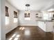 Bright dining room with hardwood floors and modern lighting, connecting to the kitchen at 413 E 40Th St, Indianapolis, IN 46205