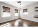 Bright dining room with hardwood floors, modern lighting, and natural light from the windows at 413 E 40Th St, Indianapolis, IN 46205