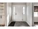 Charming entryway with coat closet, white door with sidelights, and stylish tile flooring at 413 E 40Th St, Indianapolis, IN 46205