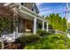 Inviting covered front porch with seating and landscaped yard at 413 E 40Th St, Indianapolis, IN 46205
