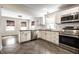 Modern kitchen with stainless steel appliances, white cabinets, and an open layout to the dining area at 413 E 40Th St, Indianapolis, IN 46205