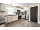 Well-lit kitchen featuring stainless steel appliances, granite countertops, and white cabinetry at 413 E 40Th St, Indianapolis, IN 46205