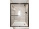 Modern shower with glass door, black hardware, tile surround, and built-in shelves at 413 E 40Th St, Indianapolis, IN 46205