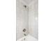 Shower with a tub and shower head surrounded by neutral-toned tile and chrome fixtures at 413 E 40Th St, Indianapolis, IN 46205