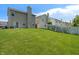 Large backyard featuring lush green grass, a privacy fence and other houses at 4136 Orchard Valley Ln, Indianapolis, IN 46235
