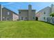 View of the grassy backyard showing the house and neighboring properties at 4136 Orchard Valley Ln, Indianapolis, IN 46235