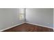 This bedroom features wood floors, neutral walls, a double-hung window and mini-blinds at 4136 Orchard Valley Ln, Indianapolis, IN 46235