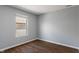 This bedroom has wood floors, neutral walls, a double-hung window and mini-blinds at 4136 Orchard Valley Ln, Indianapolis, IN 46235