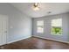 A serene bedroom with neutral walls, hardwood floors, and windows offering natural light and outdoor views at 4136 Orchard Valley Ln, Indianapolis, IN 46235