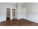 Spacious bedroom with multiple doors leading to closet and bath; features hardwood floors and neutral walls at 4136 Orchard Valley Ln, Indianapolis, IN 46235