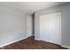 This bedroom has wood floors, neutral walls and a closet with bi-fold doors at 4136 Orchard Valley Ln, Indianapolis, IN 46235