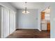 Dining room featuring hardwood floors and a view into the kitchen at 4136 Orchard Valley Ln, Indianapolis, IN 46235