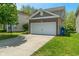 Picture of home with attached two-car garage, brick facade, and green lawn on a sunny day at 4136 Orchard Valley Ln, Indianapolis, IN 46235