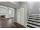 Open-concept living space featuring hardwood floors, a fireplace, and stairs to the second floor at 4136 Orchard Valley Ln, Indianapolis, IN 46235
