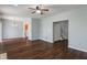 Open-concept living room with hardwood floors, neutral walls, and a ceiling fan at 4136 Orchard Valley Ln, Indianapolis, IN 46235