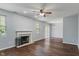 Spacious living room featuring hardwood floors, neutral paint, a ceiling fan, and natural light at 4136 Orchard Valley Ln, Indianapolis, IN 46235