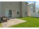 Concrete patio with a table and bench with sliding glass doors leading inside at 4136 Orchard Valley Ln, Indianapolis, IN 46235