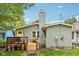 The exterior of the home features a backyard with a deck, chimney, and well-maintained lawn area at 4245 Guilford Ave, Indianapolis, IN 46205