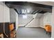 Finished basement area showcasing exposed ceiling, storage, and carpeted floors; great for entertaining at 4245 Guilford Ave, Indianapolis, IN 46205