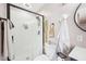 The renovated bathroom showcases a glass-enclosed shower with a black trim and a stylish vanity area at 4245 Guilford Ave, Indianapolis, IN 46205