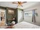 Comfortable bedroom featuring fresh white walls, a ceiling fan, and a window with natural light at 4245 Guilford Ave, Indianapolis, IN 46205