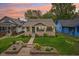 Charming home with well-manicured lawn, stone accents, a covered front porch, and lovely curb appeal at 4245 Guilford Ave, Indianapolis, IN 46205