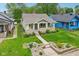 Charming home with a stone foundation, inviting front porch, lush lawn, and beautifully landscaped front yard at 4245 Guilford Ave, Indianapolis, IN 46205