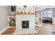 Close up of a white brick fireplace with tiled hearth, flanked by built-in shelves at 4245 Guilford Ave, Indianapolis, IN 46205