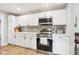Kitchen featuring white cabinets, subway tile backsplash, stainless steel appliances and quartz countertops at 4245 Guilford Ave, Indianapolis, IN 46205